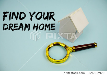 Find Your Dream Home text with White Model House and magnifying glass on blue background 126662970