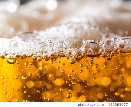 A golden-colored beer with popping bubbles 126663077