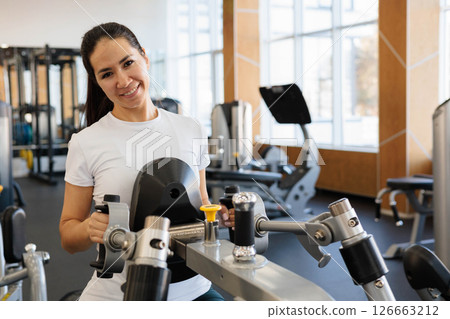 Young beautiful Asian woman with athletic build and good figure exercises 126663212