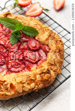 Delicious homemade strawberry galette cooling on a wire rack 126663659