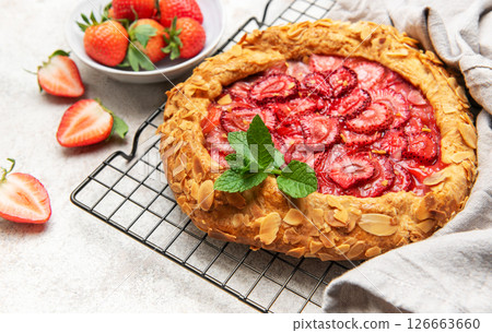 Delicious homemade strawberry galette cooling on wire rack 126663660
