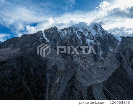 Aerial view of beautiful high altitude forest canyon and snow capped mountain landscape Aerial view of beautiful high altitude forest canyon and snow capped mountain landscape 126663896