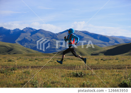 Fitness woman trail runner running in grassland 126663950