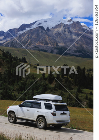 Driving off road car on the high altitude grassland mountains Driving off road car on the high altitude grassland mountains 126663954