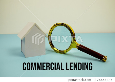 Commercial Lending text with White Model House and magnifying glass on blue background Commercial Lending text with White Model House and magnifying glass on blue background 126664287
