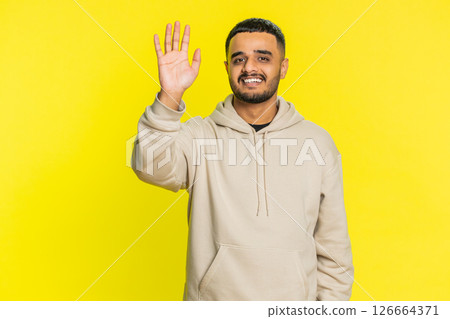 Happy man smiling friendly waving hands gesturing hello greeting or goodbye, meeting invitation 126664371