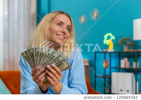 Smiling businesswoman counting cash money dollar checking salary enjoy richness at office workplace 126664382