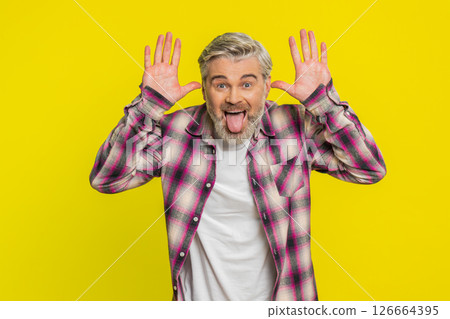 Mature man sticking out tongue, playful goofy expression, comedic silly face teasing humor vibe Mature man sticking out tongue, playful goofy expression, comedic silly face teasing humor vibe 126664395