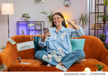 Money cash dollar rain falling on woman celebrating success, winning, good news lottery jackpot luck 126664406