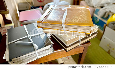 A bound photo album and a room being tidied up A bound photo album and a room being tidied up 126664408