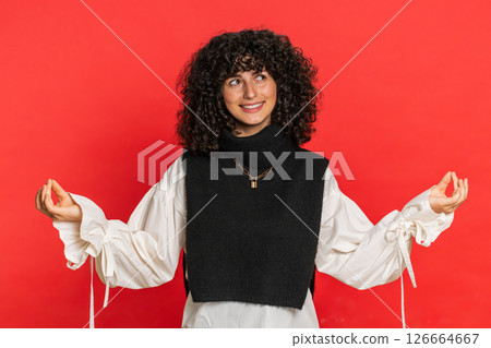 Young woman breathes deeply, eyes closed, meditating with concentrated thoughts, peaceful mind Young woman breathes deeply, eyes closed, meditating with concentrated thoughts, peaceful mind 126664667