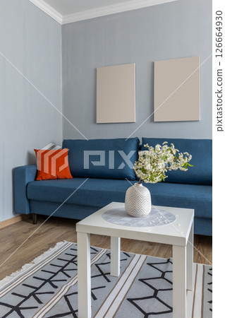 Cozy Blue Sofa with Floral Accent Table Cozy Blue Sofa with Floral Accent Table 126664930