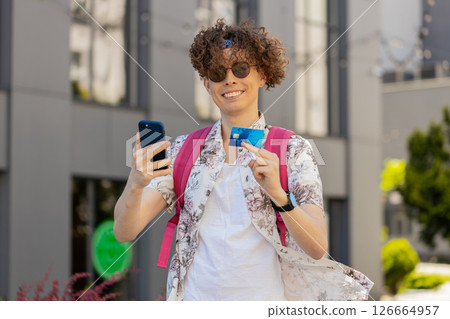 Tourist man using credit bank card smartphone while transferring money, purchases online shopping 126664957