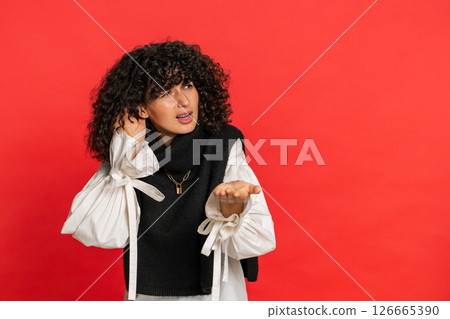 Caucasian woman trying hear you looking confused and frowning, keeping arm near ear for louder voice Caucasian woman trying hear you looking confused and frowning, keeping arm near ear for louder voice 126665390