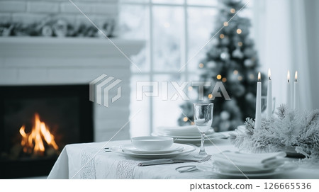 Elegant white decor enhances an informal Christmas dinner with a cozy fireplace and sophisticated cuisine on a sunny winter day 126665536