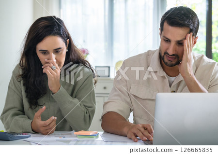 Couple overwhelmed by overdue bills and low income, facing economic stress and inflation-related financial crisis 126665835