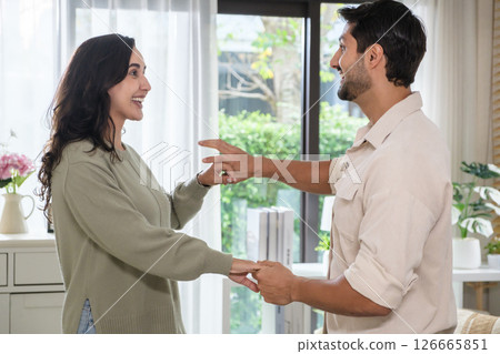 Happy couple dancing at home in joyful movement and playful emotion, celebrating love, lifestyle, Happy couple dancing at home in joyful movement and playful emotion, celebrating love, lifestyle, 126665851
