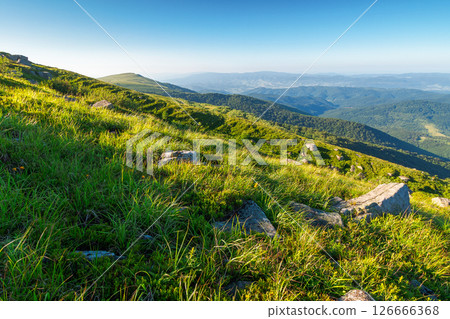 scenic view of alpine landscape in summer. picturesque outdoor background with grass on hill and blue sky with clouds. hiking through wonderful carpathian alps. majestic view from grassy mountain top 126666368