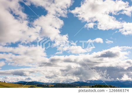 heavy clouds on a blue sky above mountains september. dramatic view. early autumn cloudy weather over carpathian range. dynamic formation 126666374