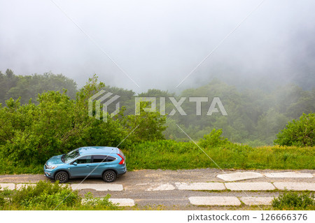 perechyn, ukraine - 22 ju2 2019: 4wd car on a countryside mountain road. reliable 4wd suv for a journey on the edge of a hill. explore highland of ukraine on a misty forenoon in summer 126666376