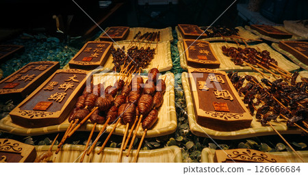 Chengdu, Sichuan, China. Insects on sticks at local Chinese market, close-up view. Various cooked insects thread on skewers. New Source Of Protein , Lipids, Minerals, And Vitamins. Fried Insects 126666684
