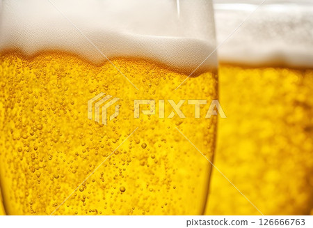 Draft beer poured into a glass 126666763