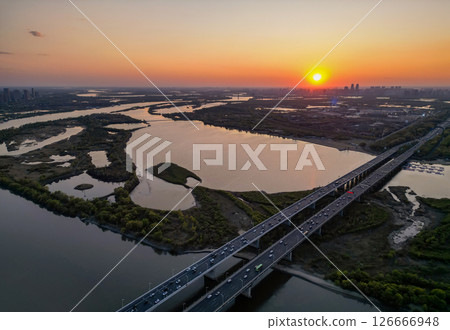 Harbin, CHINA-MAY 05, 2025-Aerial cityscape of Harbin city of Songhua river and sunset, is the capital of Heilongjiang, China. It is the largest city of Heilongjiang 126666948