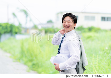 A young male field engineer turns around and says hello after work A young male field engineer turns around and says hello after work 126667391