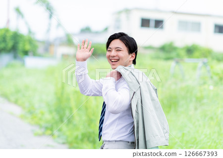 A young male field engineer turns around and says hello after work 126667393