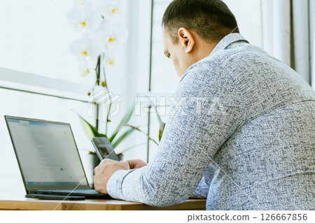 Man using ChatGPT in the mobile phone. This app is a chatbot based on Artificial Intelligence developed by OpenAI. ROSARIO, ARGENTINA - FEBRUARY 22, 2024 126667856