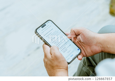 Close-up of a man's hand using AI 126667857