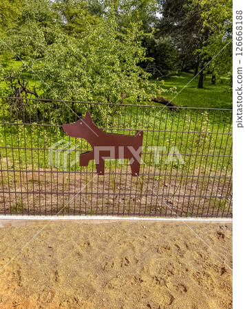 Dog shape sign on fence at a green park for dog-friendly area or pet zone. High quality photo Dog shape sign on fence at a green park for dog-friendly area or pet zone. High quality photo 126668188