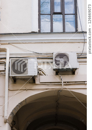 Air conditioning on facade of building and windows in the southern hot country. 126669073