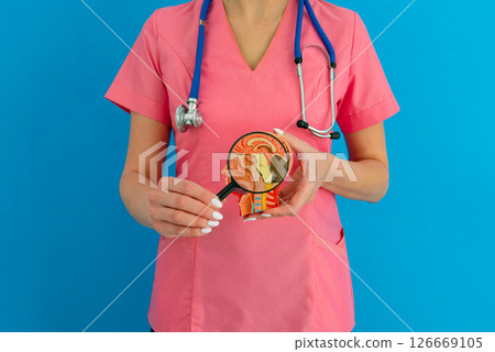 Female doctor with magnifying glass anatomical model human brain. Concept of early diagnosis of brain diseases 126669105