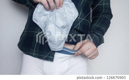 Incontinence pads for men. Urinary incontinence. Sanitary pads for men with problems of the genitourinary system. Urine leakage due to prostatitis or stress. Incontinence pads for men. Urinary incontinence. Sanitary pads for men with problems of the genitourinary system. Urine leakage due to prostatitis or stress. 126670905