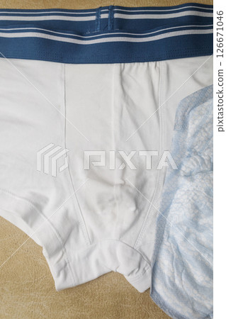 Male incontinence pads on white panties. Incontinence pads for men. Urinary incontinence. Sanitary pads for men with problems of the genitourinary system.  126671046