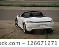 Porsche 718 Boxster sports car open-top car standing in a parking lot 126671271