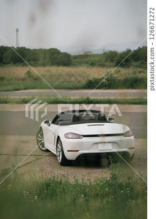 Porsche 718 Boxster sports car open-top car standing in a parking lot Porsche 718 Boxster sports car open-top car standing in a parking lot 126671272