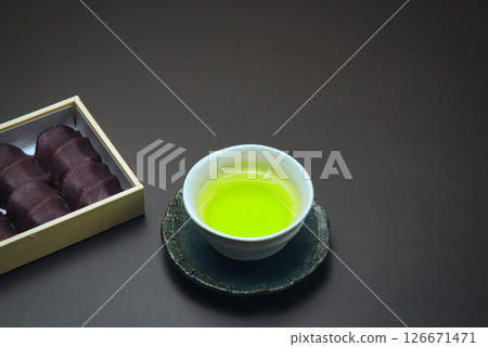Enjoy this delicious Japanese confectionery, made of soft mochi wrapped in smooth bean paste, with some Japanese tea. Enjoy this delicious Japanese confectionery, made of soft mochi wrapped in smooth bean paste, with some Japanese tea. 126671471