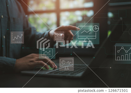 Businessman analyzing data dashboard with futuristic digital interface in modern office. Businessman analyzing data dashboard with futuristic digital interface in modern office. 126671501