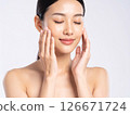 A woman with her hands on her face, an image of beauty 126671724
