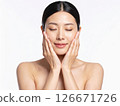 A woman feeling refreshed with facial care 126671726