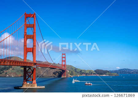 Golden Gate Bridge over blue waters with scenic hills in San Francisco Golden Gate Bridge over blue waters with scenic hills in San Francisco 126671869