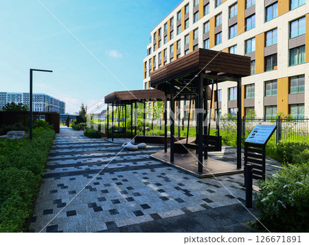 Contemporary Modern Outdoor Lounge Area Designed with Comfortable Shelters and Abundant Greenery 126671891