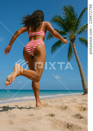 Woman in red white bikini running on sunny beach 126672798