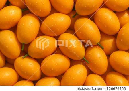 AI generated top view of ripe marian plums with water droplets under daylight showing freshness clean surface and vibrant tropical appeal 126673133