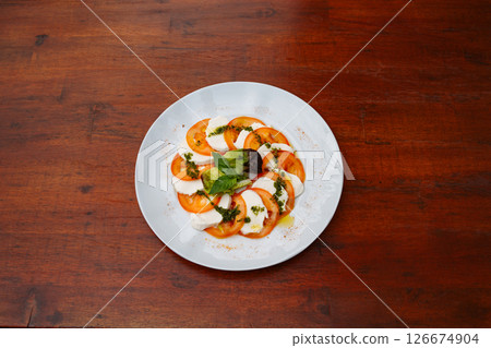 Tomato and Mozzarella Carpaccio. Delicious italian freshly prepared meal, perfect for menus, restaurants, or food delivery concepts. Tomato and Mozzarella Carpaccio. Delicious italian freshly prepared meal, perfect for menus, restaurants, or food delivery concepts. 126674904