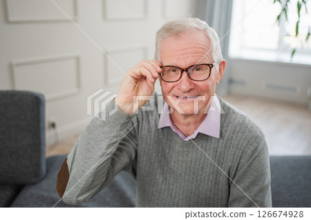 Portrait of confident stylish European middle aged senior man at home. Older mature 70s man smiling. Happy attractive senior grandfather looking camera close up face headshot portrait. Happy people Portrait of confident stylish European middle aged senior man at home. Older mature 70s man smiling. Happy attractive senior grandfather looking camera close up face headshot portrait. Happy people 126674928