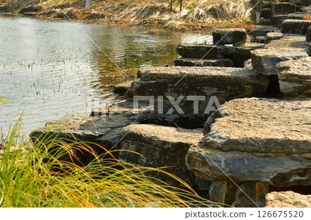 Photo of rocks near a pond in autumn Photo of rocks near a pond in autumn 126675520