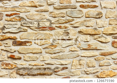 Textured Stone Wall with Natural Colors and Rough Surface 126675590